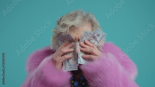 Funny grandmother old woman posing on colored background. Grandma influencer with fashionable clothes on stage, Concept about seniority and third age