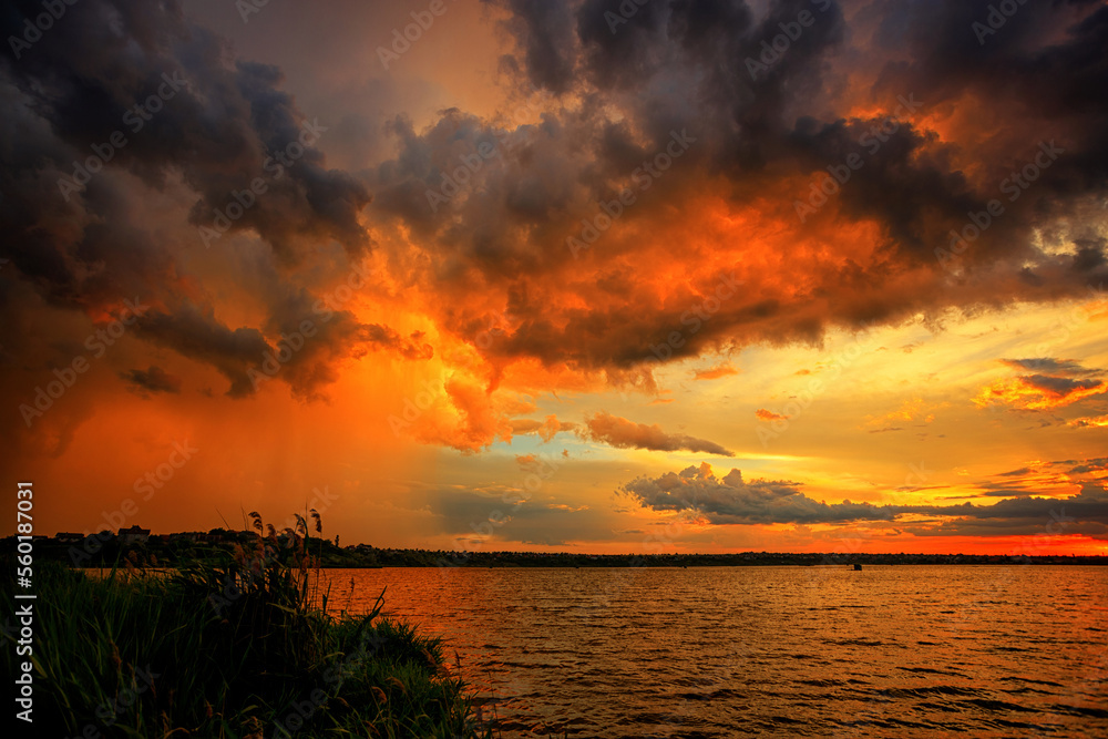 Fantastically beautiful sunset on the shore of the lake