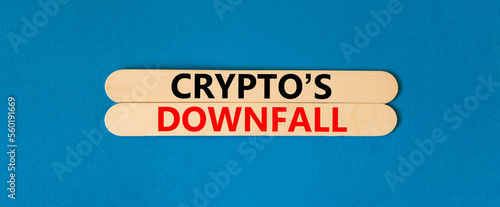 Crypto downfall symbol. Concept words Cryptos downfall on wooden stick. Beautiful blue table blue background. Business and crypto downfall concept. Copy space.