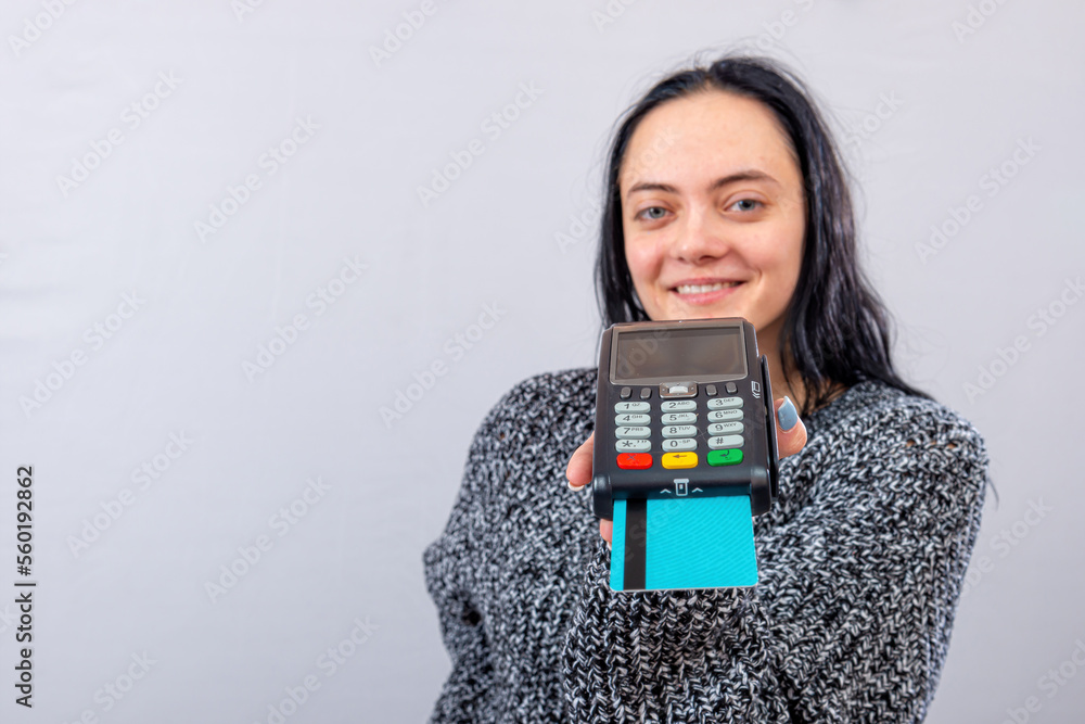 caucasian woman holding payment terminal and giving it to the customer can pay with credit card