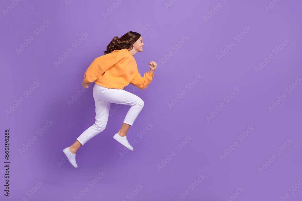 Full size profile portrait of excited crazy person jumping running empty space isolated on purple color background