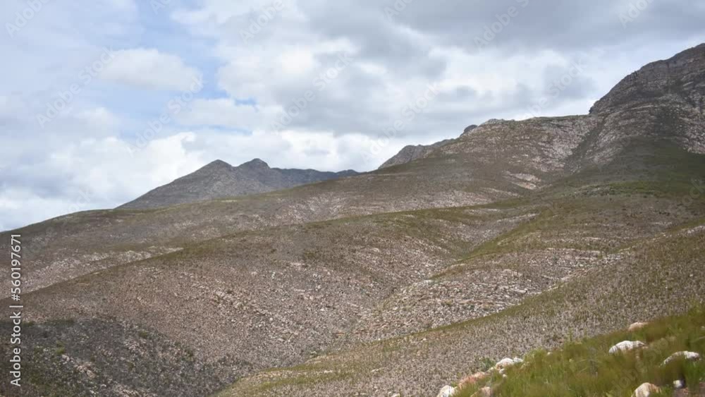 a hyperlaps of clouds moving over the cloetesberg mountain range in the little karoo semi desert area of the western cape province of south africa 