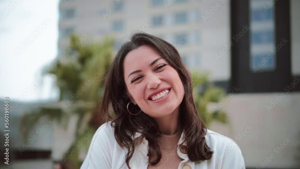 Portrait of young woman smiling and looking at camera with white tooth standing outdoors. Front view of happy teenage girl with positive attitude. High quality 4k footage Portrait of young woman smiling and looking at camera with white tooth standing outdoors. Front view of happy teenage girl with positive attitude. High quality 4k footage
