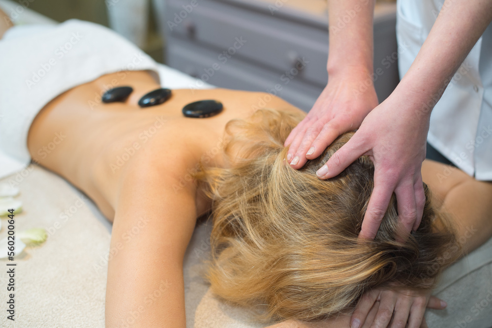 Naklejka premium woman with hot stones on the back