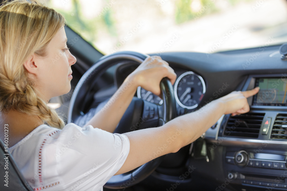 woman setting vehicle navigation system woman setting vehicle navigation system