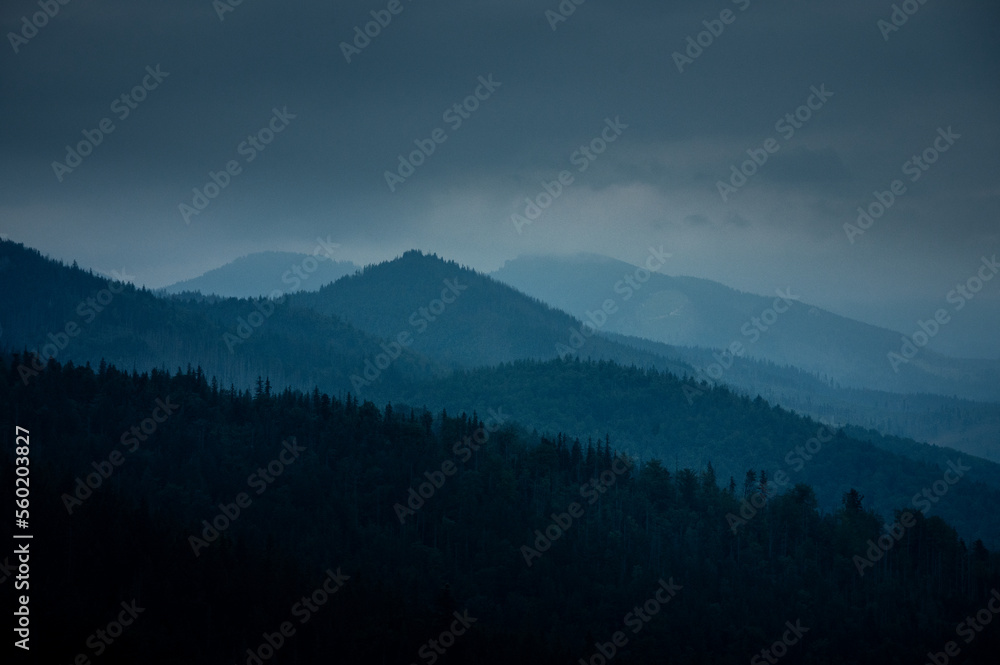 Breathtaking views over the valley of impressive Tatra mountains in misty weather. National park in Zakopane, Poland.