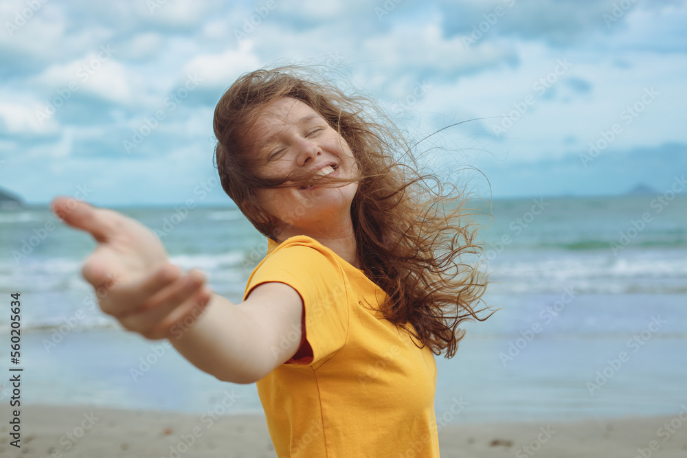 Portrait of happy positive red hair girl, young beautiful carefree woman enjoying summer vacation at sea, beach in exotic tropical country Portrait of happy positive red hair girl, young beautiful carefree woman enjoying summer vacation at sea, beach in exotic tropical country