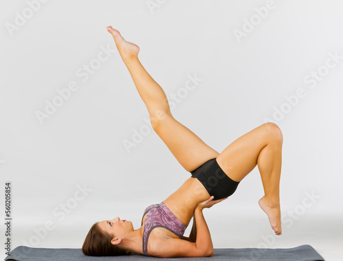 Brunette Yoga Fitness Model Exercises In A Studio Environment