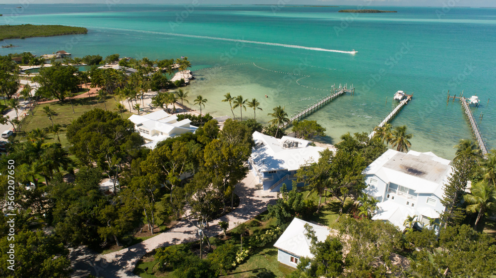 Florida Keys waterfront homes with boat running by.