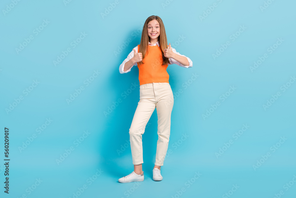Full length photo of cheerful pretty lady wear stylish outfit advise quality clothes isolated on blue color background Full length photo of cheerful pretty lady wear stylish outfit advise quality clothes isolated on blue color background