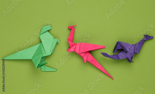 Origami dragons on a green background