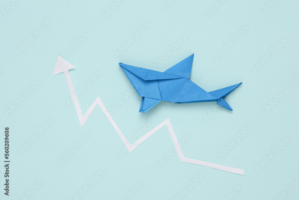 Origami shark with growth arrow on blue background Origami shark with growth arrow on blue background