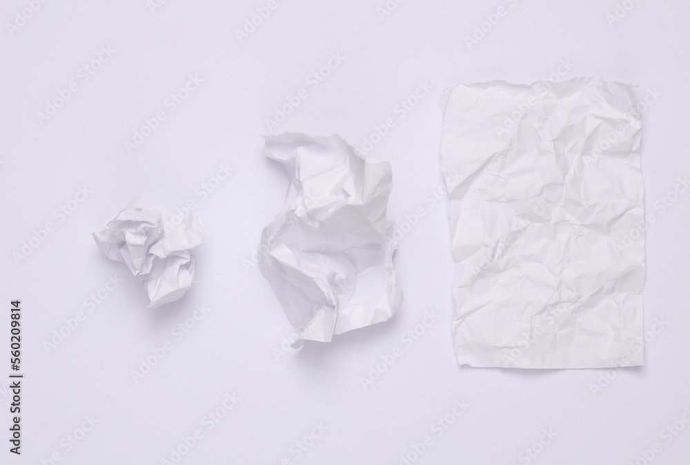 Step by step process of crumpling paper into a ball on a white background