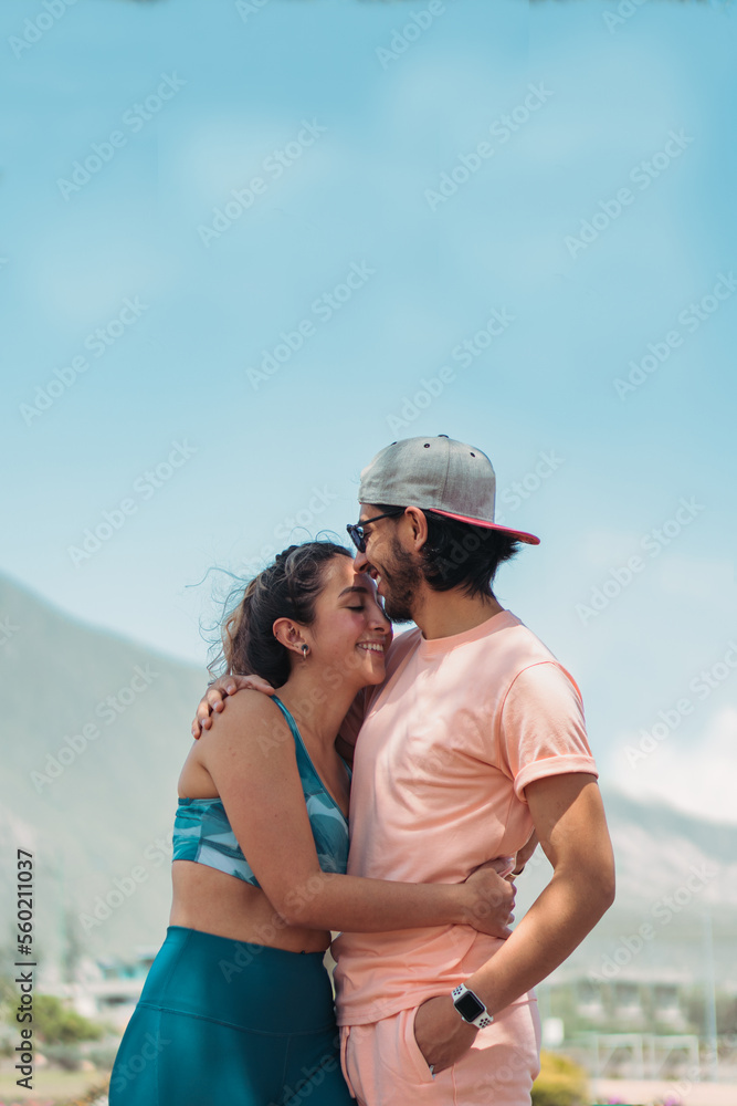 Happy couple hugging against mountains Happy couple hugging against mountains