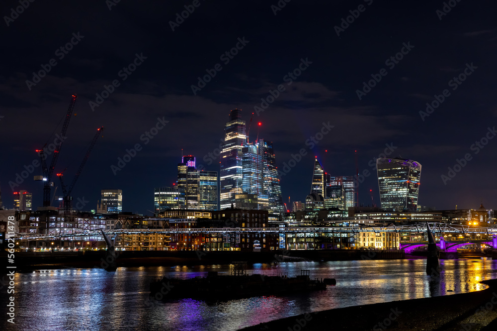 Beautiful view of the city of London by night, glittering skyscrapers across the river Thames