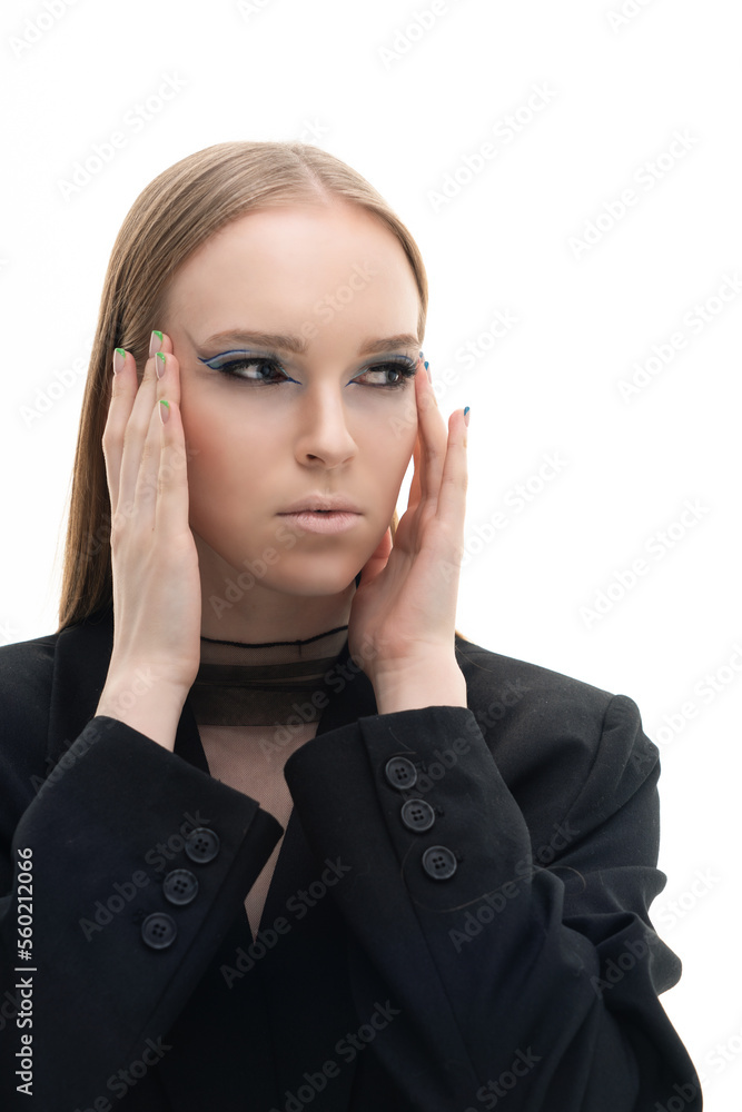 Fashion portrait of a young girl in a black suit, black bra and transparent top. The model poses on a white background. Art makeup. Photography in the studio. Fashion portrait of a young girl in a black suit, black bra and transparent top. The model poses on a white background. Art makeup. Photography in the studio.