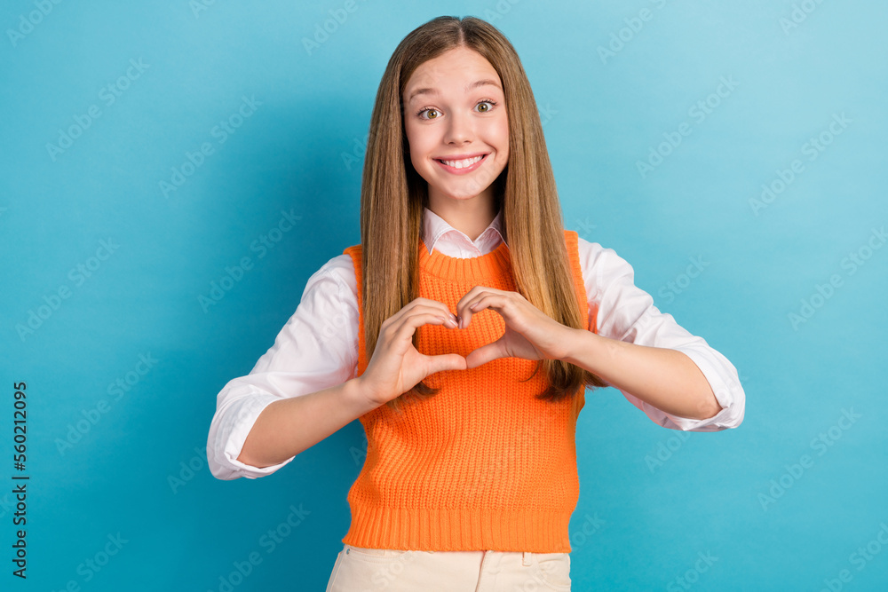 Photo of positive lovely lady wear stylish clothes arms make heart figure symbol isolated on blue color background Photo of positive lovely lady wear stylish clothes arms make heart figure symbol isolated on blue color background