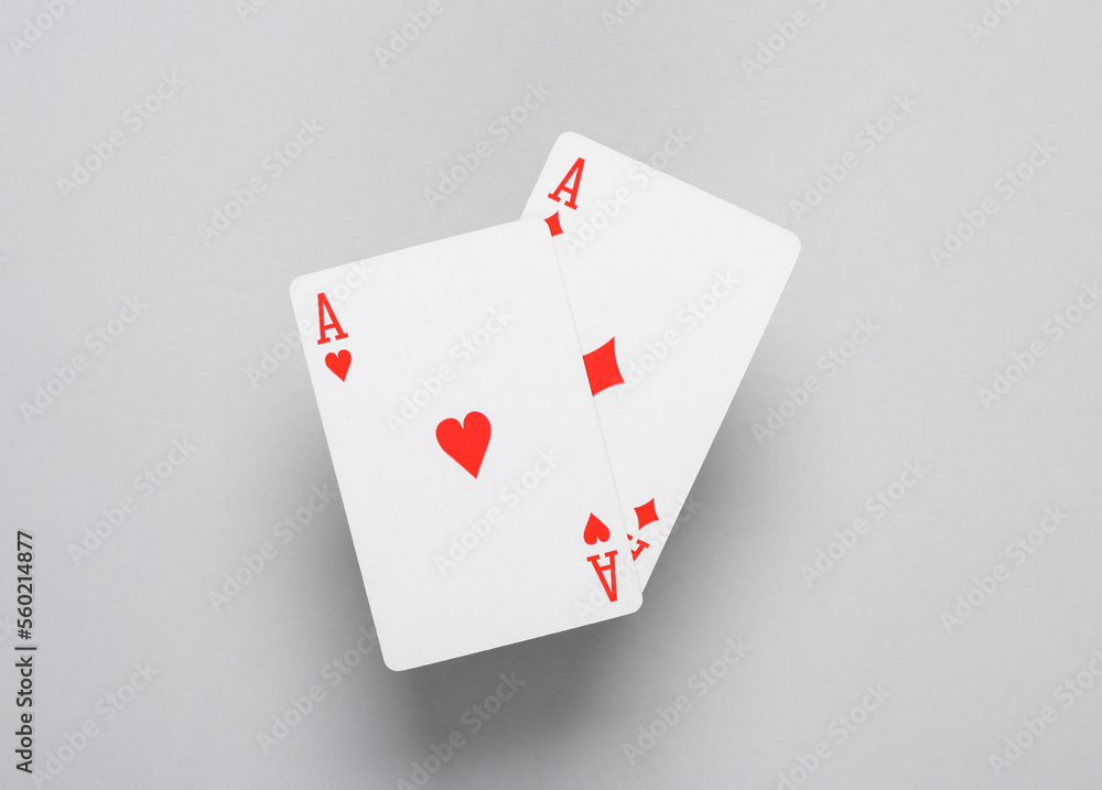 Ace of diamonds and hearts on a gray background. Playing cards Ace of diamonds and hearts on a gray background. Playing cards