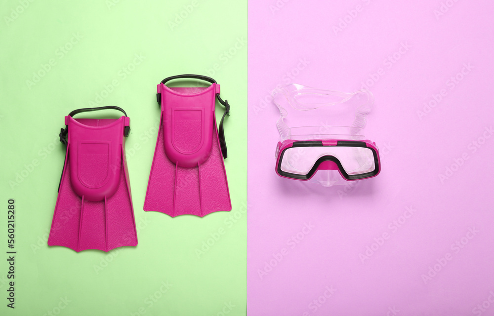 Pink Diving mask and fins on colored pastel background. Travel concept, vacation at sea. Flat lay, top view Pink Diving mask and fins on colored pastel background. Travel concept, vacation at sea. Flat lay, top view