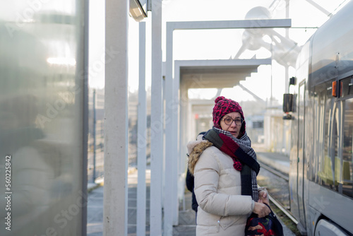 Картината върху платно Adult woman with wool cap, waits at the tram station in Brussels to go to work