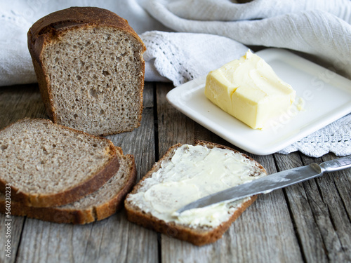 Rye bread and some butter to spread on the slices. Close up. Horizontal, rustic