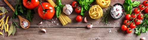 Uncooked pasta, vegetables, cooking food background