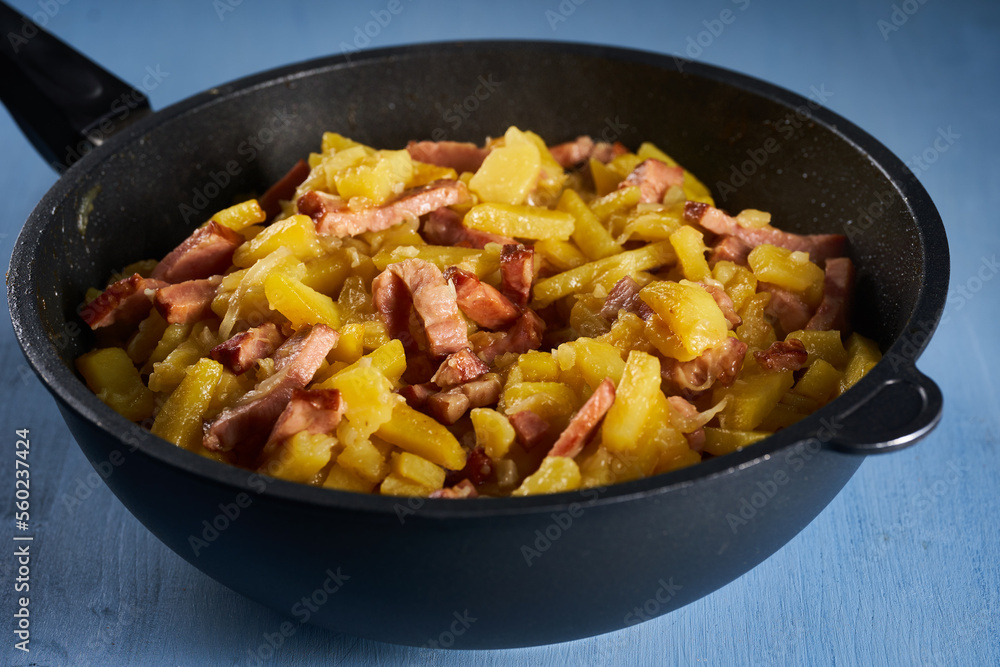 Potatoes and ham in a wok Potatoes and ham in a wok