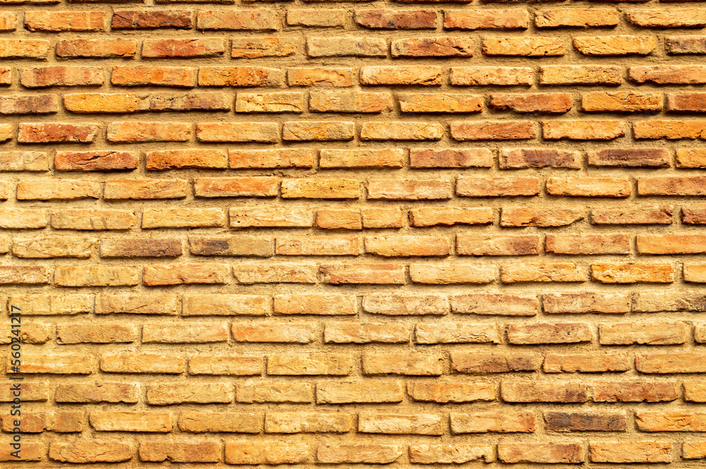 Obraz premium Wall of brown, red and orange bricks. Pattern. Advertising space. Design element. Background. Horizontal.