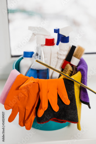 Bucket with detergent and gloves for house cleaning. Professional home cleaning service. Housekeeping domestic cleaning service.
