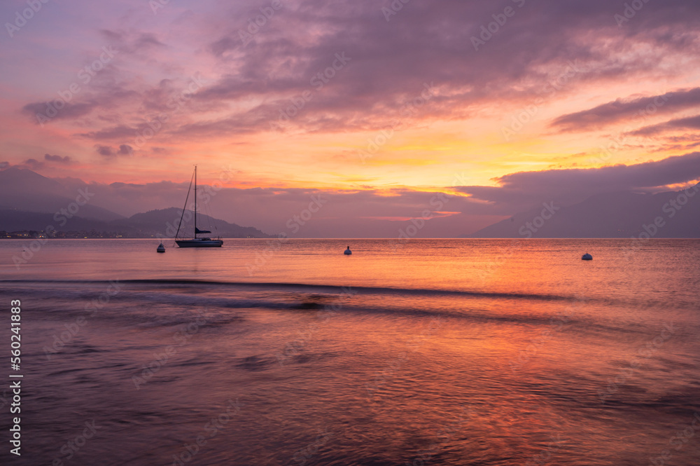 Beautiful sunset over the sea with red and purple colored clouds and water with silky effect from long exposure