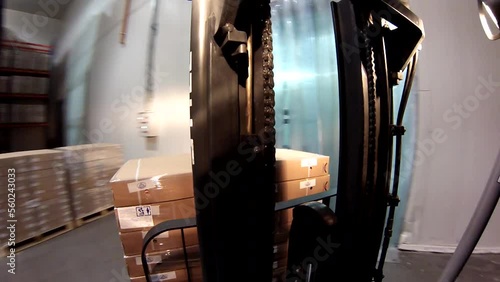 Forklift loads boxes into truck and truck. Loading goods in a logistics center