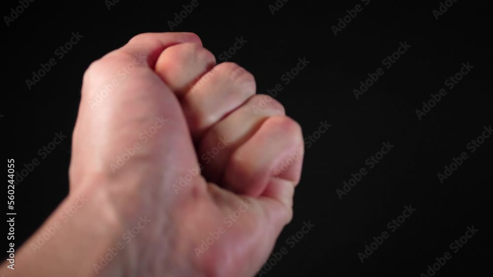 A man's hand begging on a black background with a coin falling into his hand 4k A man's hand begging on a black background with a coin falling into his hand 4k