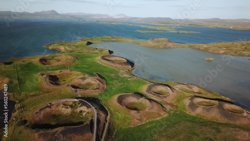 4K drone aerial footage over volcanic pseudo craters Skutustadagigar in lake Myvatn. Huge cones of pseudo craters on the Icelandic shore. Aerial of Skutustadagigar Pseudocrater Area in Iceland. photo