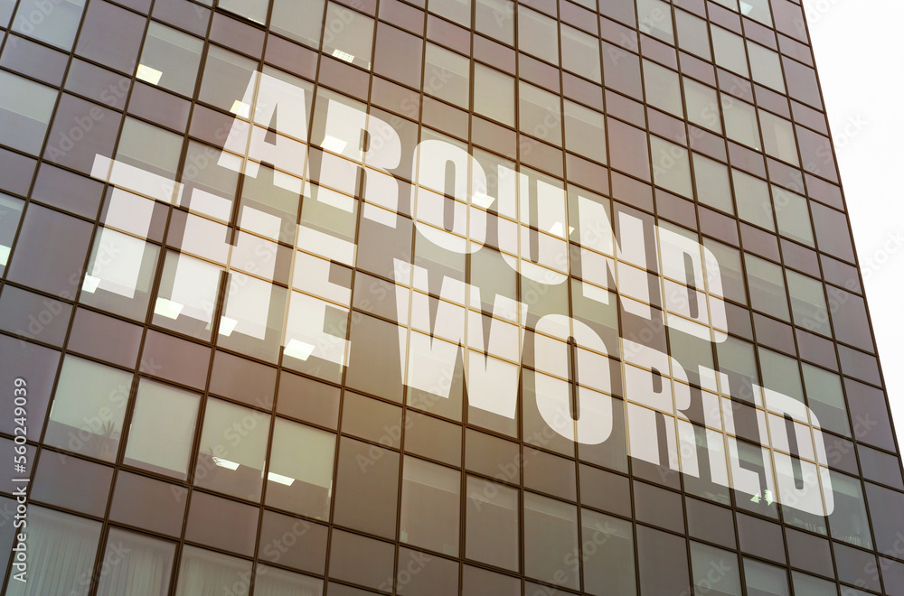 Obraz premium On the glass surface of the business center there is an inscription - Around the World