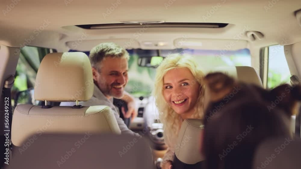 Family getting ready to go on a car road trip, beginning of summer vacation Family getting ready to go on a car road trip, beginning of summer vacation