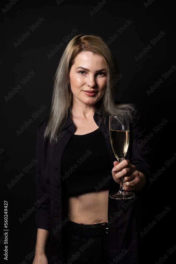 woman with a glass on a black background woman with a glass on a black background