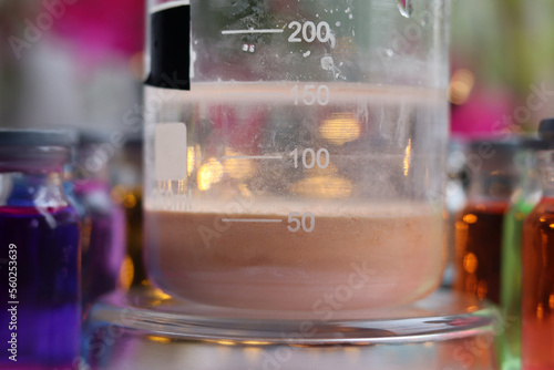 Preparation of a brown insoluble substance of manganese sulfide in a beaker. photo