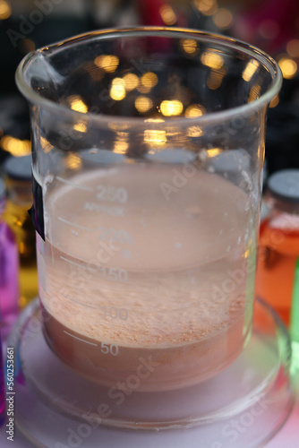 Chemical beaker with brown insoluble manganese sulfide at the bottom.