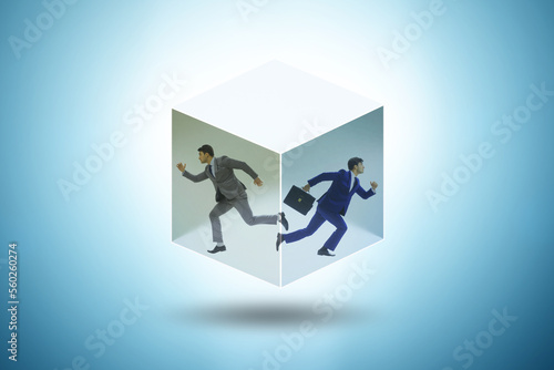 Businessman trapped in transparent glass cube