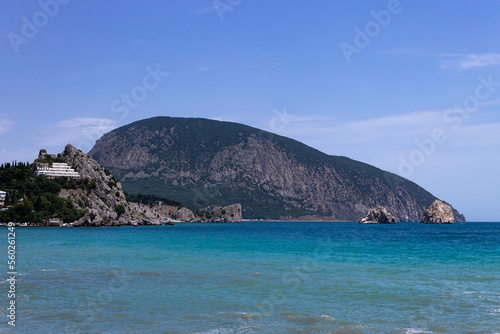 Bear mountain on the sea shore at summer photo