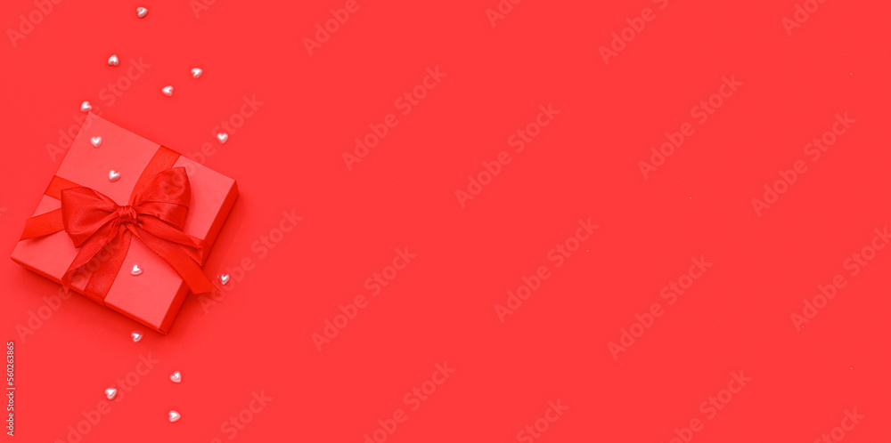 Gift with decor on red background with space for text. Valentines Day celebration Gift with decor on red background with space for text. Valentines Day celebration
