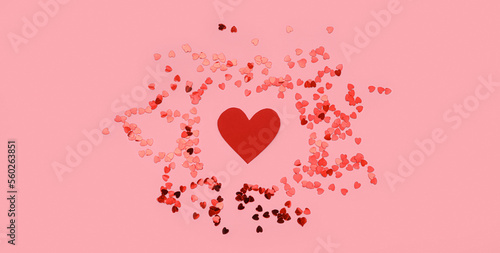 Composition with red paper heart and confetti on pink background. Valentines Day celebration