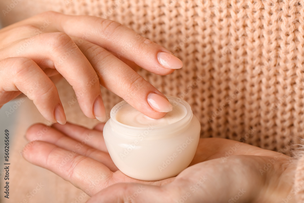 Woman holding jar of cream, closeup Woman holding jar of cream, closeup