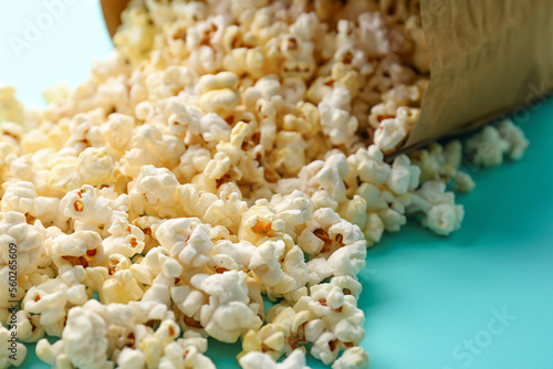 Scattered popcorn on color background, closeup