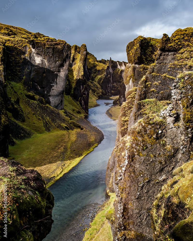 A river runs through the cliffs of Fjadrargljufur, Iceland