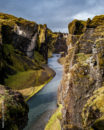 A river runs through the cliffs of Fjadrargljufur, Iceland