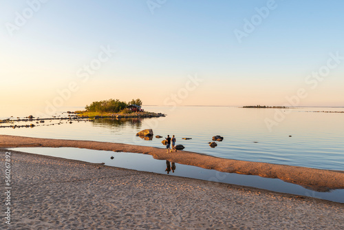 Father and daughter walking on a beach. Ohtakari, Kokkola. Finland