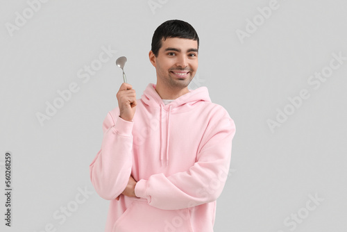 Young man with silver spoon...