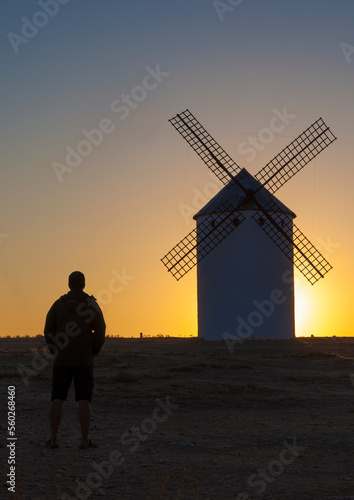 Man observing Campo de Criptana windmills, Spain photo