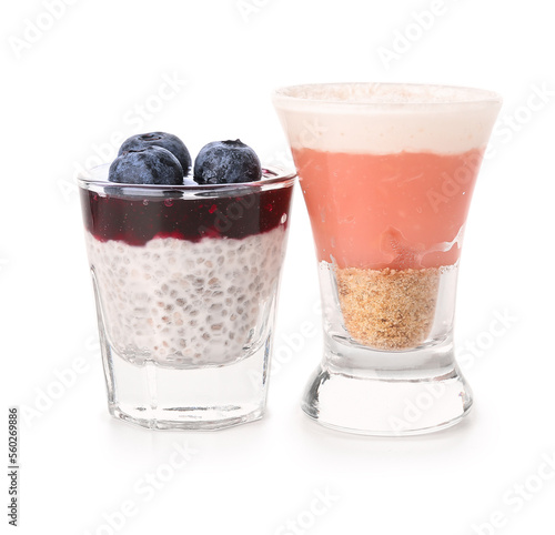 Shots of pudding with coconut shavings  blueberry and chia seeds isolated on white background